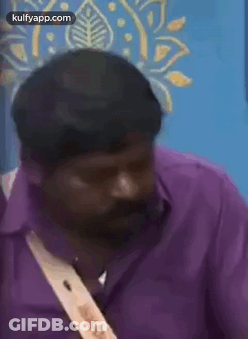 Man In Purple Shirt Talking On Cell Phone GIF