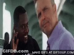 Man In Purple Shirt Talking On Phone With Another GIF
