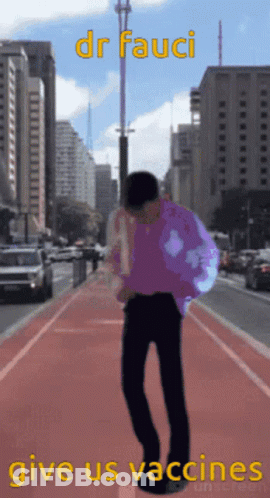 Man In Purple Shirt Walking City GIF