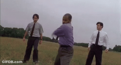 Man In Purple Shirt With Two Others In Field GIF
