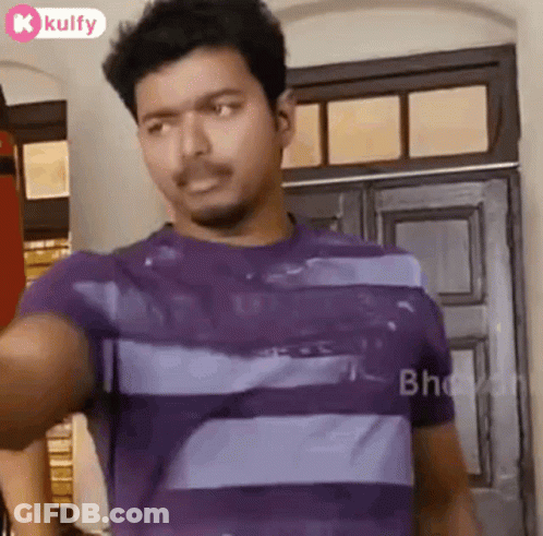 Man In Purple Striped Shirt At Door Looking At Camera GIF