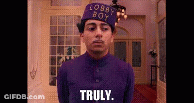 Man In Purple Suit And Hat Standing In Room GIF