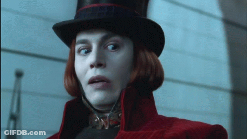 Man In Purple Suit And Top Hat Smiling Talking To Another Man GIF
