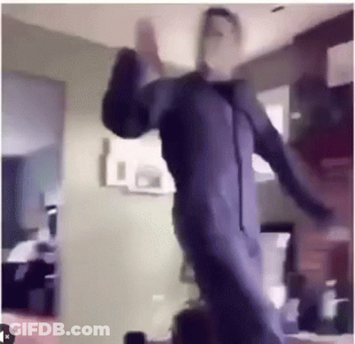 Man In Purple Suit Dancing In Living Room GIF
