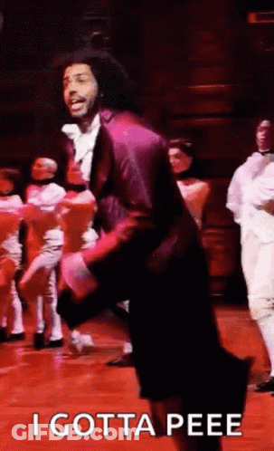 Man In Purple Suit Dancing On Stage GIF
