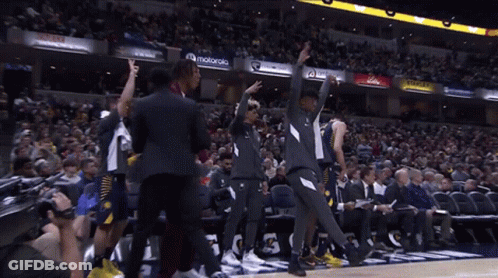 Man In Purple Suit Giving Peace Sign At Motorola Sign GIF