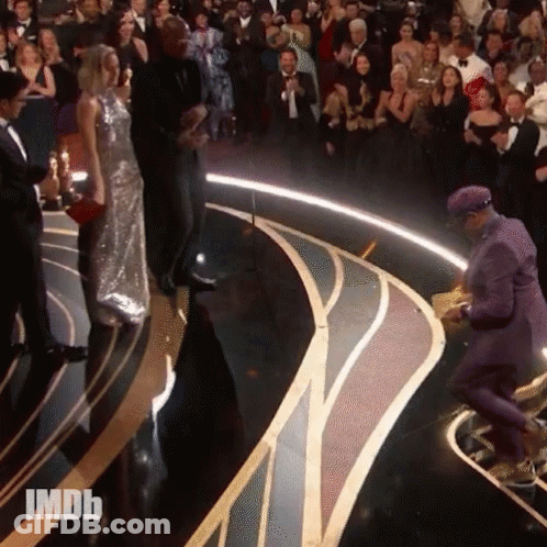 Man In Purple Suit On Stage With IMDB Crowd GIF
