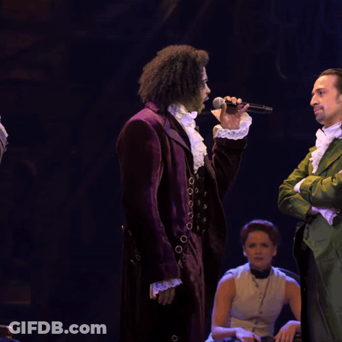 Man In Purple Suit Singing Into Microphone GIF