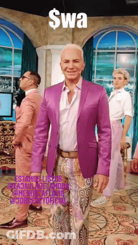 Man In Purple Suit Standing In Front Of Swa Sign GIF