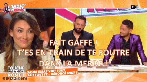 Man In Purple Suit Standing Next To Woman On TV Show GIF