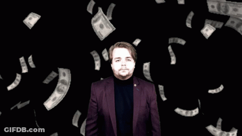 Man In Purple Suit Surrounded By Hundred Dollar Bills GIF