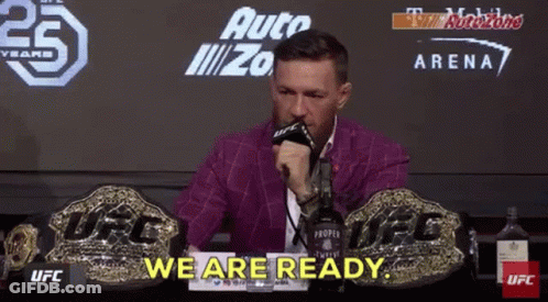 Man In Purple Suit Talking Into Microphone GIF