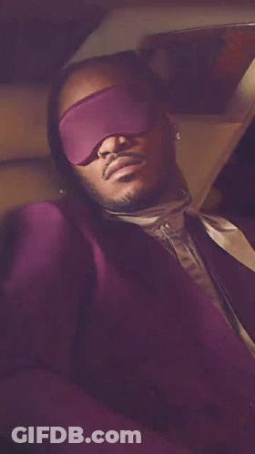 Man In Purple Suit With Blindfold GIF
