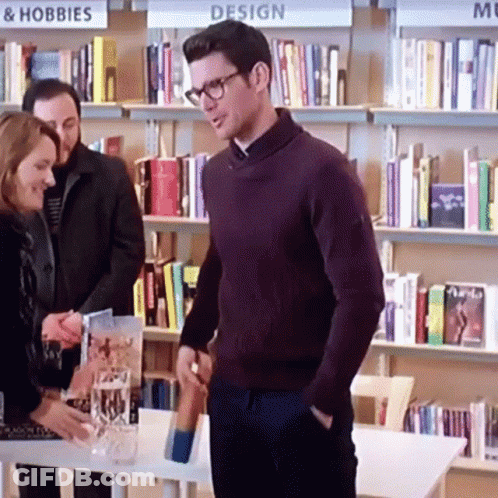 Man In Purple Sweater And Glasses At Design Sign GIF