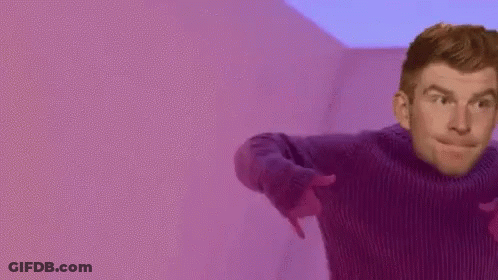 Man In Purple Sweater Pointing GIF