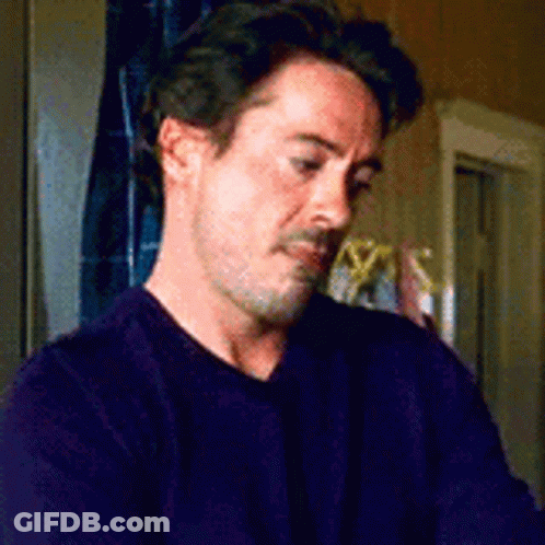 Man In Purple Sweater Sitting GIF