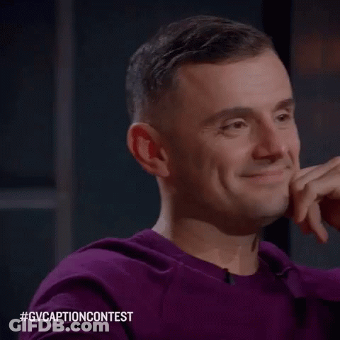 Man In Purple Sweater Smiling Hand To Chin GIF