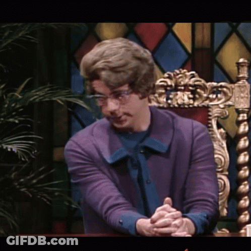 Man In Purple Sweater With Folded Hands GIF
