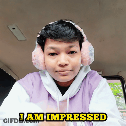 Man In Purple Sweatshirt And Ear Muffs Saying I Am Impressed GIF