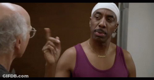 Man In Purple Tank Talking To Man With Glasses GIF
