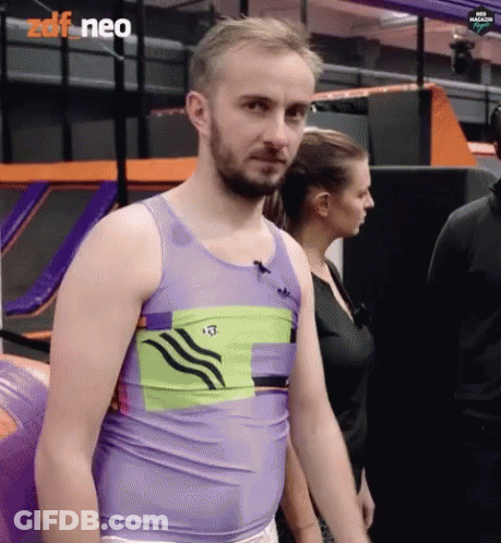 Man In Purple Tank Top Standing In Front Of Woman In Black Shirt GIF