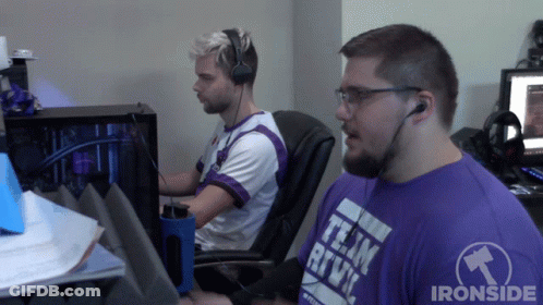Man In Purple Team Rive Shirt Sitting Next To Another Man GIF