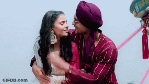 Man In Purple Turban Hugging Woman In Pink Dress GIF