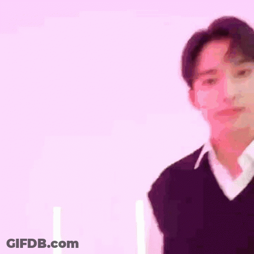 Man In Purple Vest And White Shirt In Front Of Pink Wall GIF