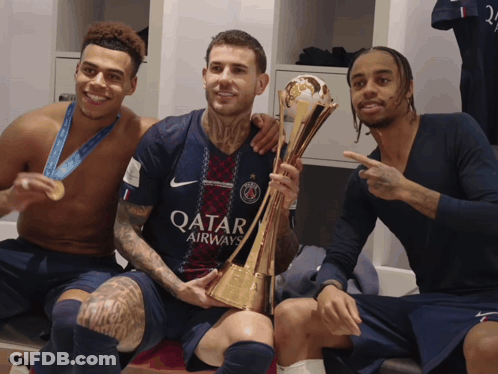 Man In Qatar Airlines Jersey Holding Trophy GIF
