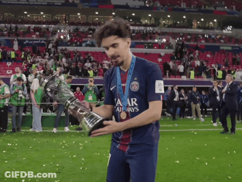 Man In Qatar Jersey Holding Trophy GIF