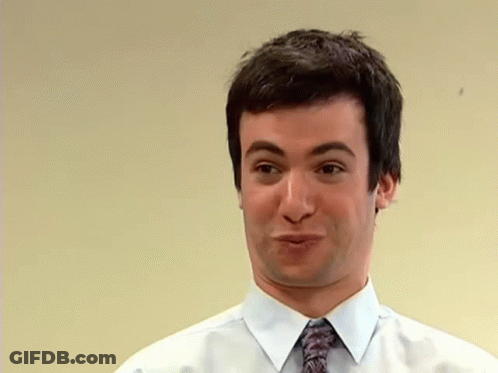Man In Race Car Standing Next To Woman In Dress GIF
