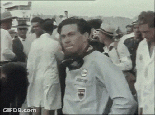 Man In Racing Shirt In Crowd GIF