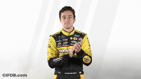 Man In Racing Suit Clapping GIF