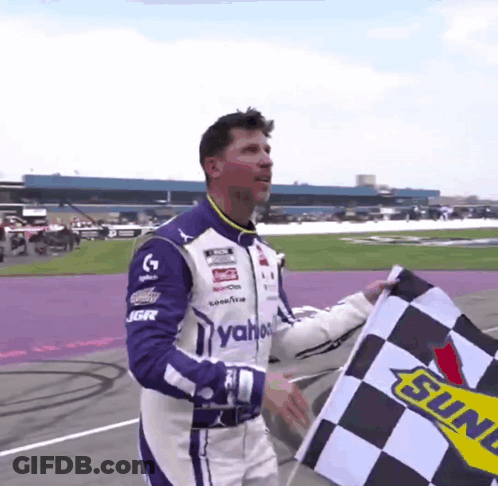 Man In Racing Suit Holding Checkered Flag Sunoco GIF