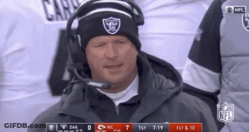 Man In Raiders Hat And Headphones On Sidelines GIF