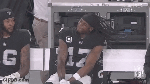 Man In Raiders Jersey Sitting On Bench GIF