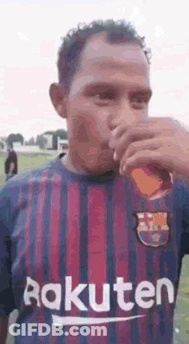 Man In Rakuten Jersey Drinking From Glass GIF