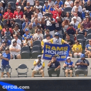 Man In Rams House Shirt Holding Banner GIF