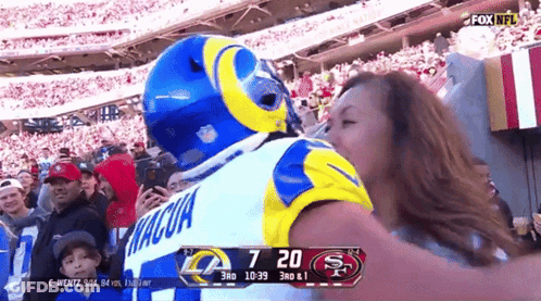 Man In Rams Jersey Kissing Woman GIF