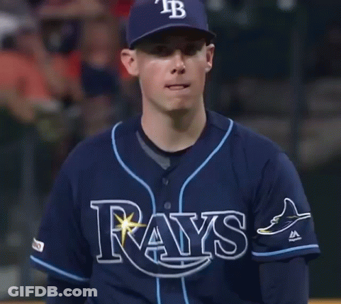 Man In Rays Jersey And Hat Looking At Camera GIF