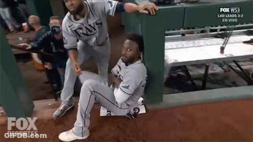 Man In Rays Jersey Being Helped By Another Man GIF