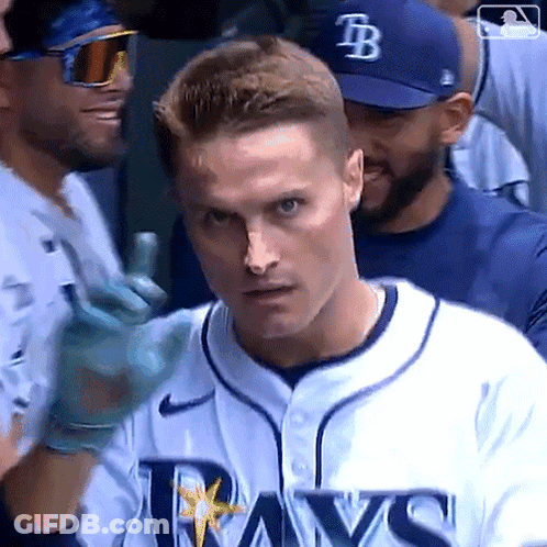 Man In Rays Jersey Standing In Crowd GIF
