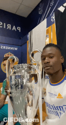 Man In Real Madrid Jersey Holding Trophy GIF