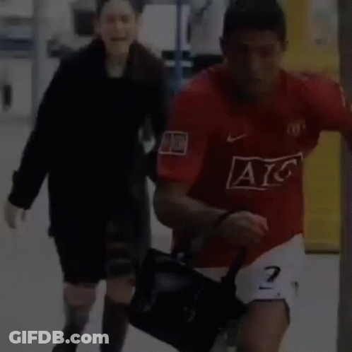 Man In Red AC Jersey Running With Woman GIF