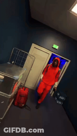 Man In Red Adidas Hoodie Talking To Another Man GIF