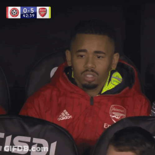 Man In Red Adidas Jacket Sitting GIF