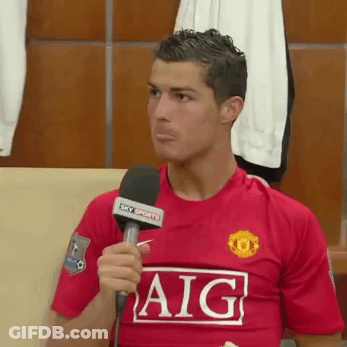 Man In Red Aig Shirt Holding Microphone GIF