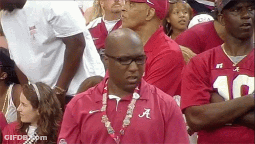 Man In Red Alabama Shirt Stands In Crowd GIF