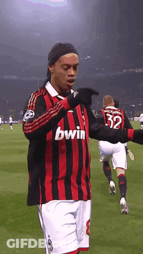 Man In Red And Black Bwin Jersey On Field GIF