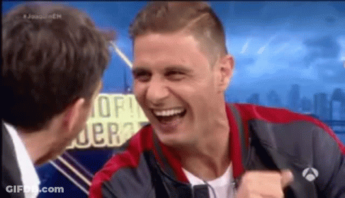 Man In Red And Black Jacket Laughing With Suit Man GIF